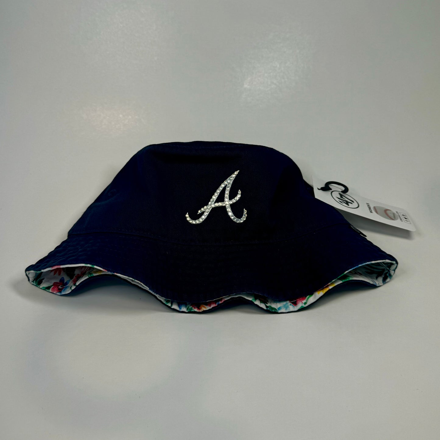 Front side view of rhinestoned Atlanta Braves baseball bucket hat with flower print