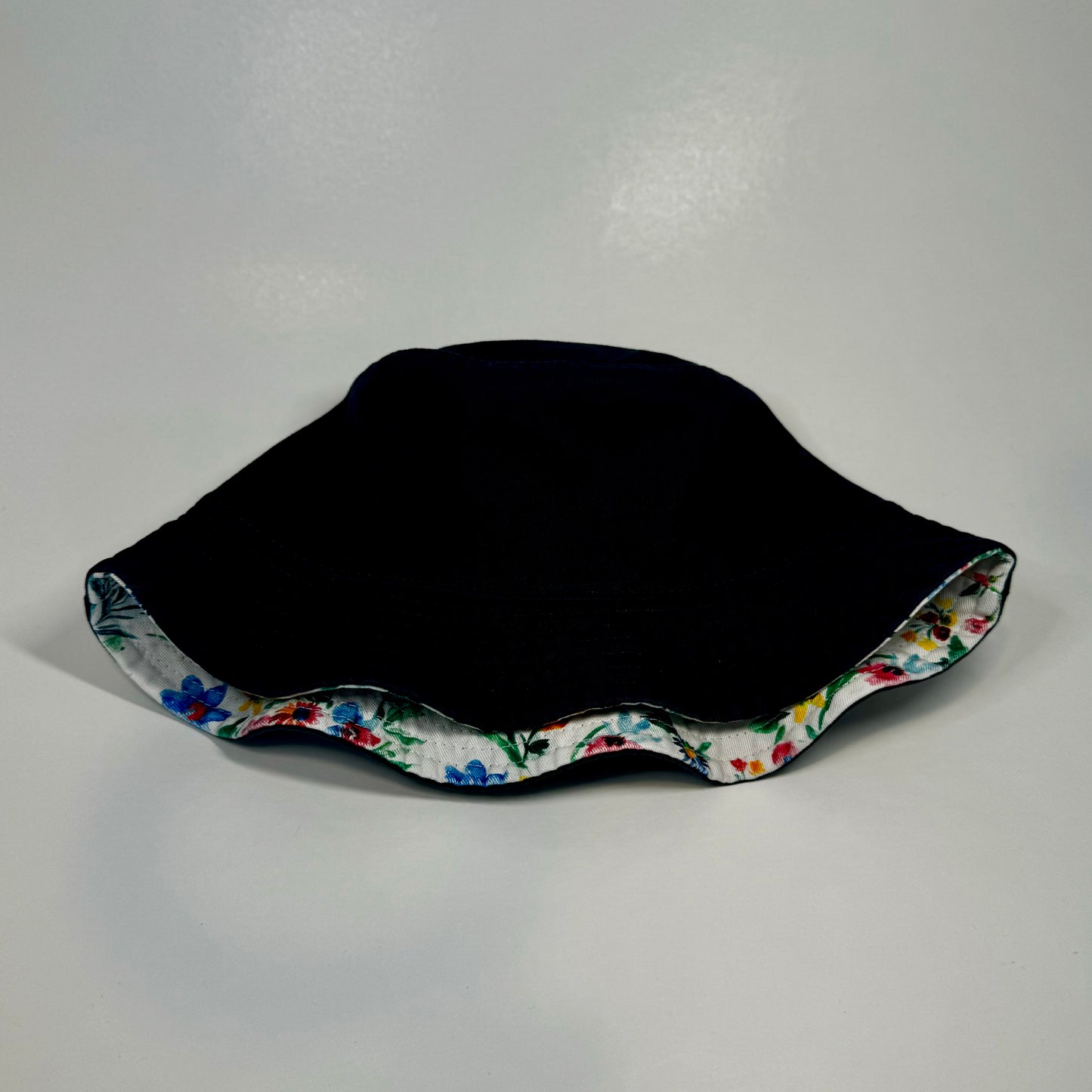 Back side view of Atlanta Braves baseball bucket hat with flower print