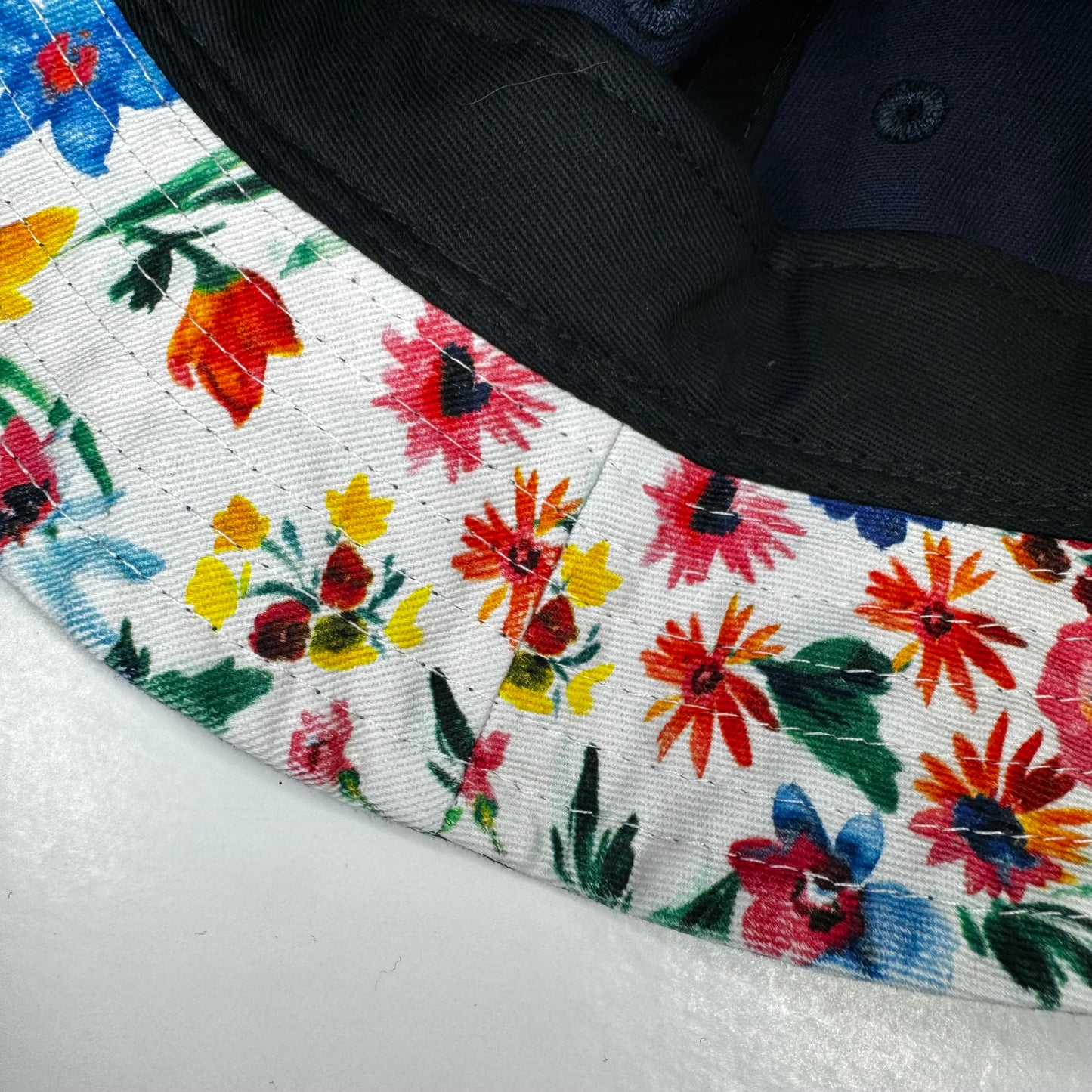 Close up of flower print on inside brim of rhinestoned Boston Red Sox baseball bucket hat